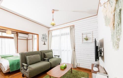 a living room with a couch and a bed at Leaf in Kamakura