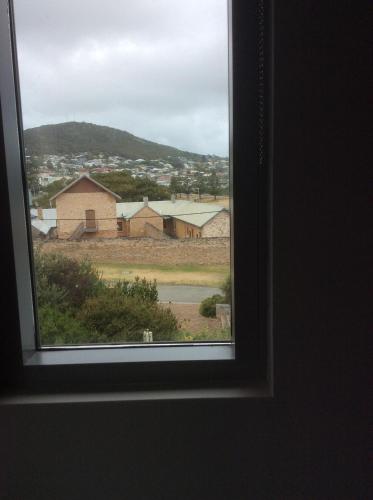 a window with a view of a field and buildings at Hanover Bay Apartments in Albany