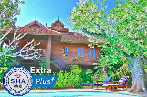 a house with a sign in front of it at Oriental Siam Resort - SHA Extra Plus Certified in Chiang Mai