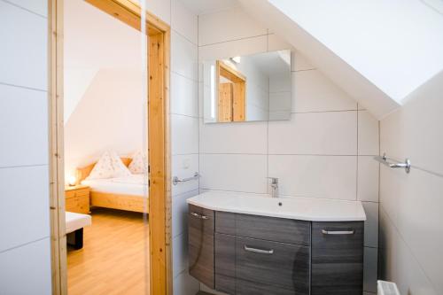 a bathroom with a sink and a mirror at Gästezimmer Steiner in Gamlitz