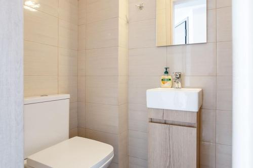 a bathroom with a white toilet and a sink at 7-Athens new morden comfortable-center,metro,private parking in Athens