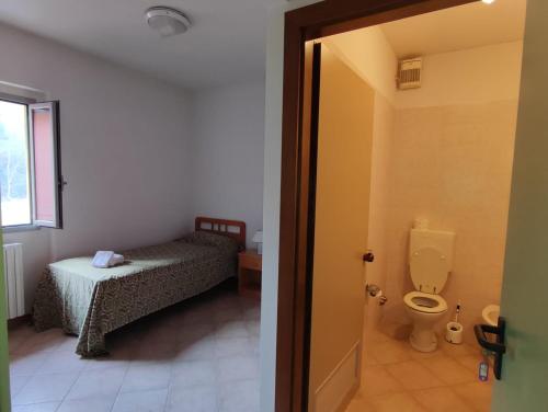 uma casa de banho com uma cama e um WC num quarto em QOELET - B&B Etico e Sociale em Montevarchi