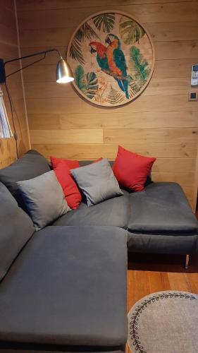 a couch with pillows on it in a room at Roulotte les Mésanges in Rebecq-Rognon