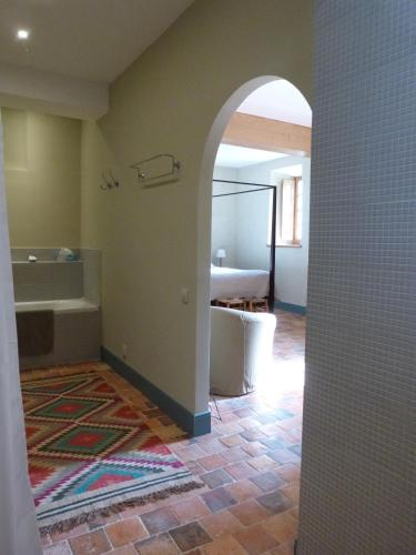 a bathroom with a tub and a sink and a room at Manoir du Plessis au Bois in Vauciennes