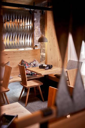 a room with a wooden table and chairs at Alpenhotel Perner in Obertauern