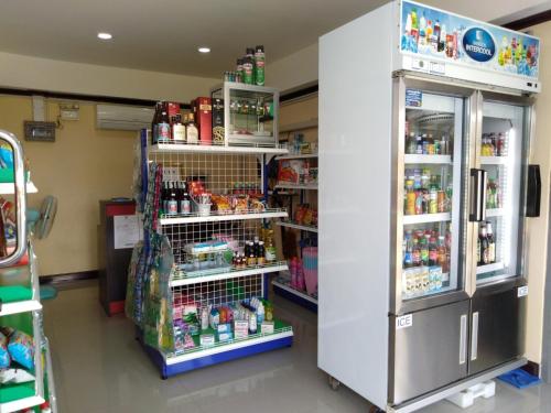 a room with a store with a refrigerator and shelves at SRS3 STUDIO APARTMENT in Ban Bang Kha