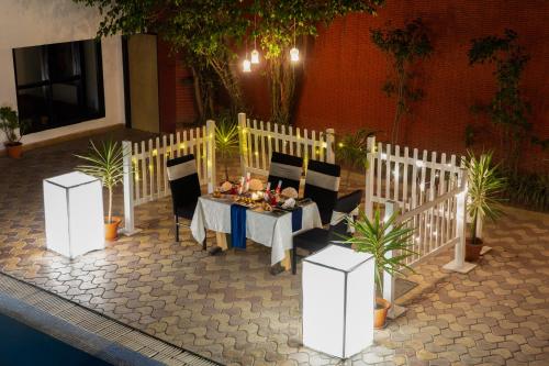 a table and chairs in a room with plants at Country Inn Nature Resort Bhimtal in Bhīm Tāl
