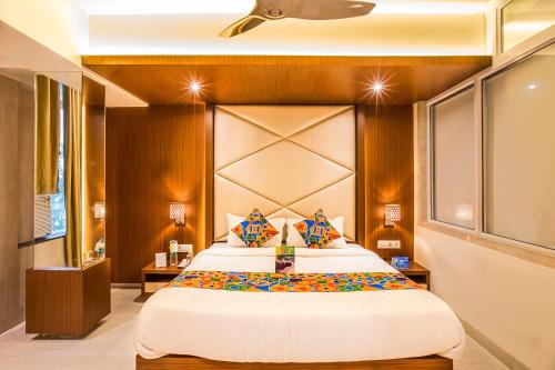 a bedroom with a large bed in a room at FabHotel Spring Inn Kandivali in Mumbai