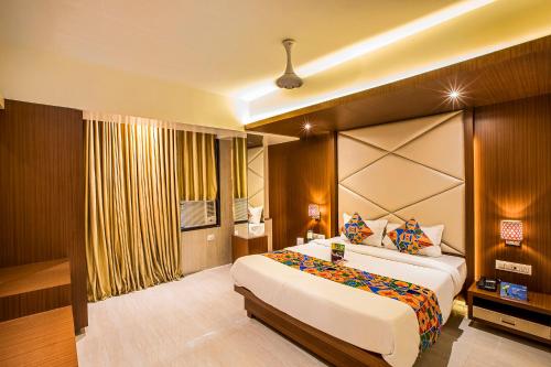 a bedroom with a large bed in a room at FabHotel Spring Inn Kandivali in Mumbai
