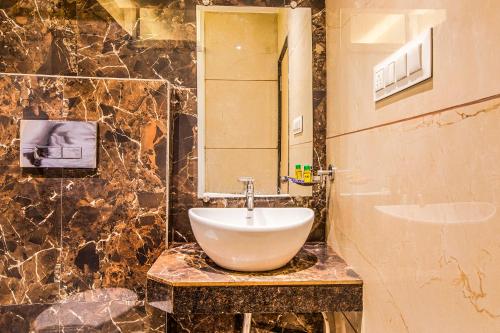a bathroom with a sink and a mirror at FabHotel Spring inn - Nr Borivali Station in Mumbai