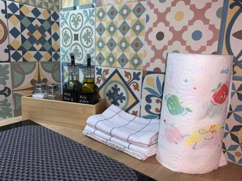 Cette chambre est dotée d'un oreiller et d'un mur avec du carrelage. dans l'établissement Le Petit Toulouse, à Niort