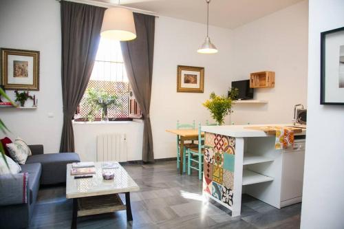 a living room with a couch and a table at BEAUTIFUL SILENT APARTMENT Private Parking in Seville