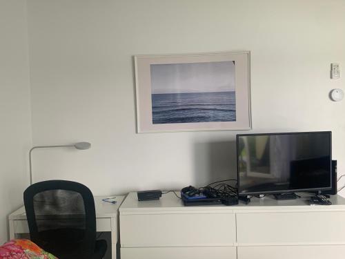 a tv sitting on top of a white cabinet at Obera Beach #105 in Freeport