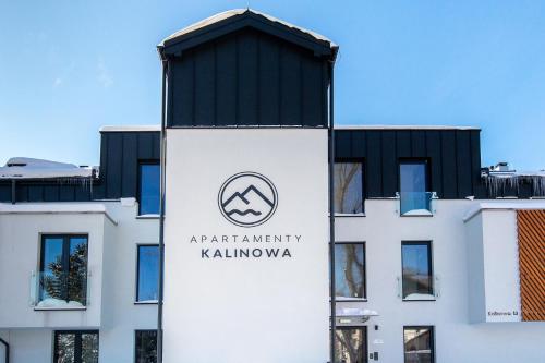 a building with a sign on the side of it at Apartament Madlen Kalinowa Szczyrk Sauna Grota Solna in Szczyrk