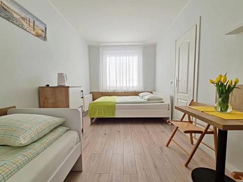 a bedroom with a bed and a desk with a table at Chatka Morska in Karwia