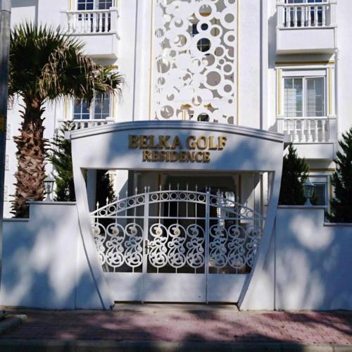 a gate in front of a building with a sign at BELKA GOLF RESİDENCE Luxury Apt Poolside Belek in Belek