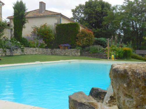 a large blue swimming pool in front of a house at les tamaris in Castelnau-sur-Gupie