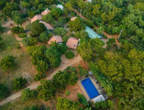 an overhead view of a house with a blue pond at Koragaha Lodge - Yala in Tissamaharama