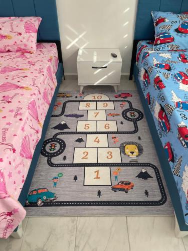 a childs bedroom with a rug with cars on it at BELKA GOLF RESİDENCE Luxury Apt Poolside Belek in Belek