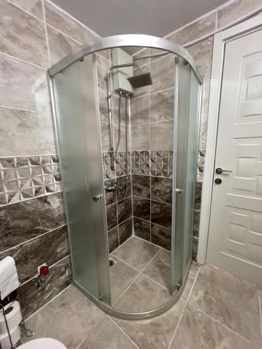 a shower with a glass door in a bathroom at BELKA GOLF RESİDENCE Luxury Apt Poolside Belek in Belek