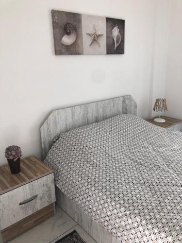 a bedroom with a large bed with a wooden nightstand at BELKA GOLF RESİDENCE Luxury Apt Poolside Belek in Belek