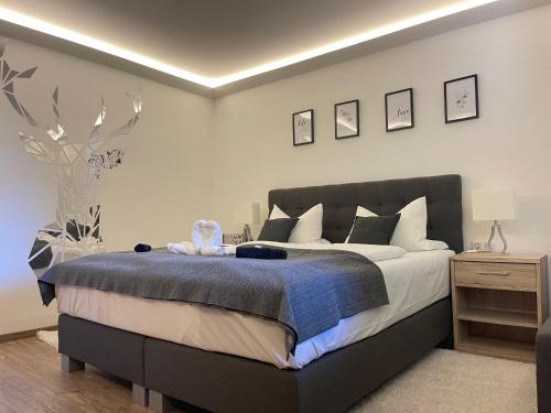 a bedroom with a bed with a blue blanket at Hohe Tanne in Aurbach