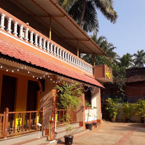 a building with christmas lights on the side of it at Sai Homestay in Malvan