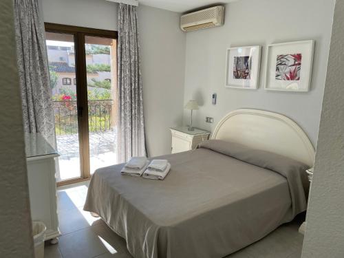 a bedroom with a bed and a large window at Apartamentos El Toro in Marbella