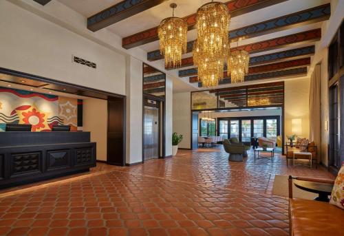 a lobby with chandeliers and a living room at Mar Monte Hotel, in The Unbound Collection by Hyatt in Santa Barbara