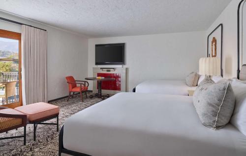 a hotel room with two beds and a flat screen tv at Mar Monte Hotel, in The Unbound Collection by Hyatt in Santa Barbara