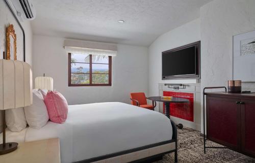 a hotel room with a bed and a television at Mar Monte Hotel, in The Unbound Collection by Hyatt in Santa Barbara
