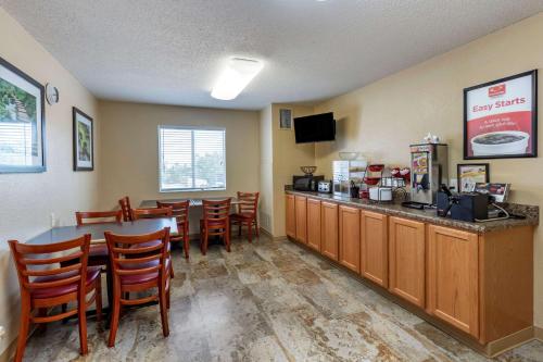 a fast food restaurant with a bar and tables and chairs at Econo Lodge in Belle Fourche