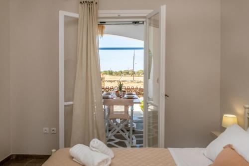 a bedroom with two beds and a view of the ocean at Θἔρως (Theros) house 1 - Agios Fokas in Tinos Town