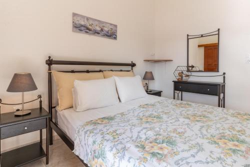 a bedroom with a bed and two night stands at Traditional House @ Chora Astypalea in Astypalaia Town