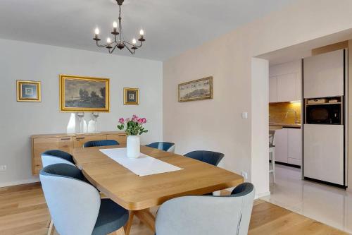 a dining room with a wooden table and blue chairs at Angel Boutique Home - Entire premium house in Laško