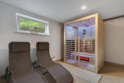 a room with two chairs and a wine cellar at Angel Boutique Home - Entire premium house in Laško
