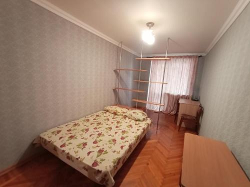 a small bedroom with a bed and a shelf at 2rooms Gagarina in Kharkiv