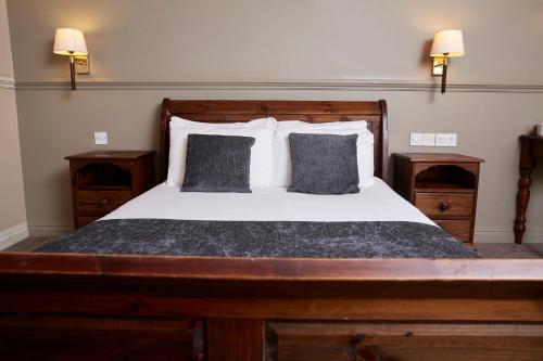 a bedroom with a large bed with two pillows at Dog House by Chef & Brewer Collection in Abingdon
