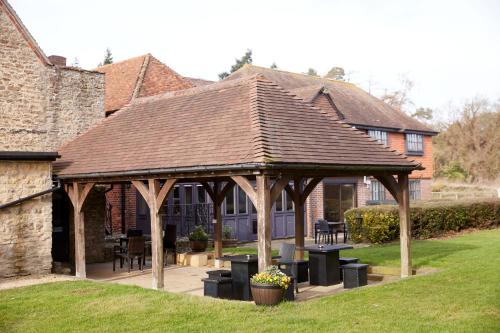 a wooden pavilion in the yard of a house at Dog House by Chef & Brewer Collection in Abingdon