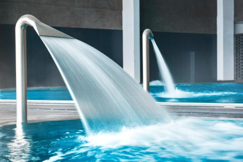 a water fountain in a swimming pool at Termy Warmińskie in Lidzbark Warmiński