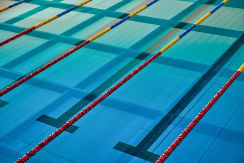a swimming pool with red and yellow dividers at Termy Warmińskie in Lidzbark Warmiński