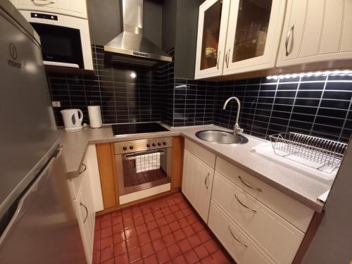 a small kitchen with a sink and a stove at InnerCity Apartments in Budapest