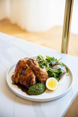 a plate of food with meat and vegetables on a table at Staybridge Suites Dubai Financial Centre by IHG in Dubai