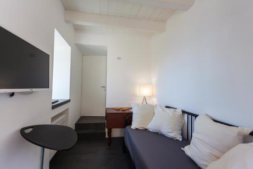 a room with a couch and a table and a tv at Green House in Maiori