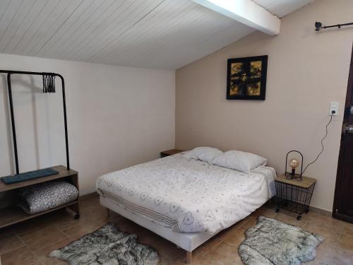 a bedroom with a bed and two rugs at Õ 2040 Chambre Marmotte in Saint-Véran
