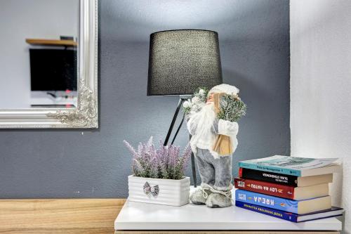 a statue of a man holding flowers on top of books at Guesthouse Check In in Stolac
