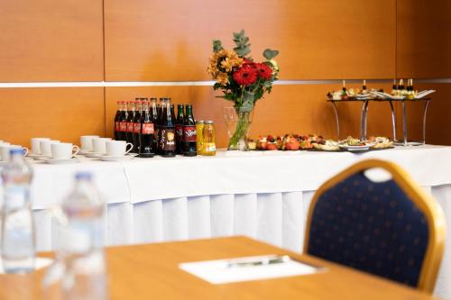 a table with a vase of flowers on a counter at Hotel Tatra in Bratislava