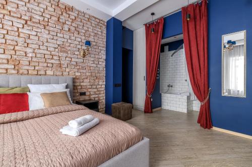 a bedroom with blue and red walls and a bed at Romantika Smolny appartment in Saint Petersburg