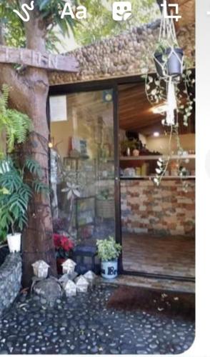 a store front with a window and a brick wall at Seabreeze Beachfront Home and Cottages new management in San Juan