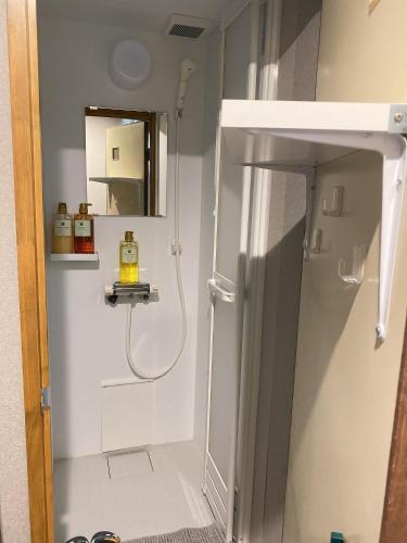 a bathroom with a shower and a sink at 瓦町駅•home 101 in Takamatsu